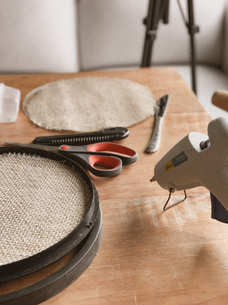 Hot glue gun used to glue burlap into place on frame. 