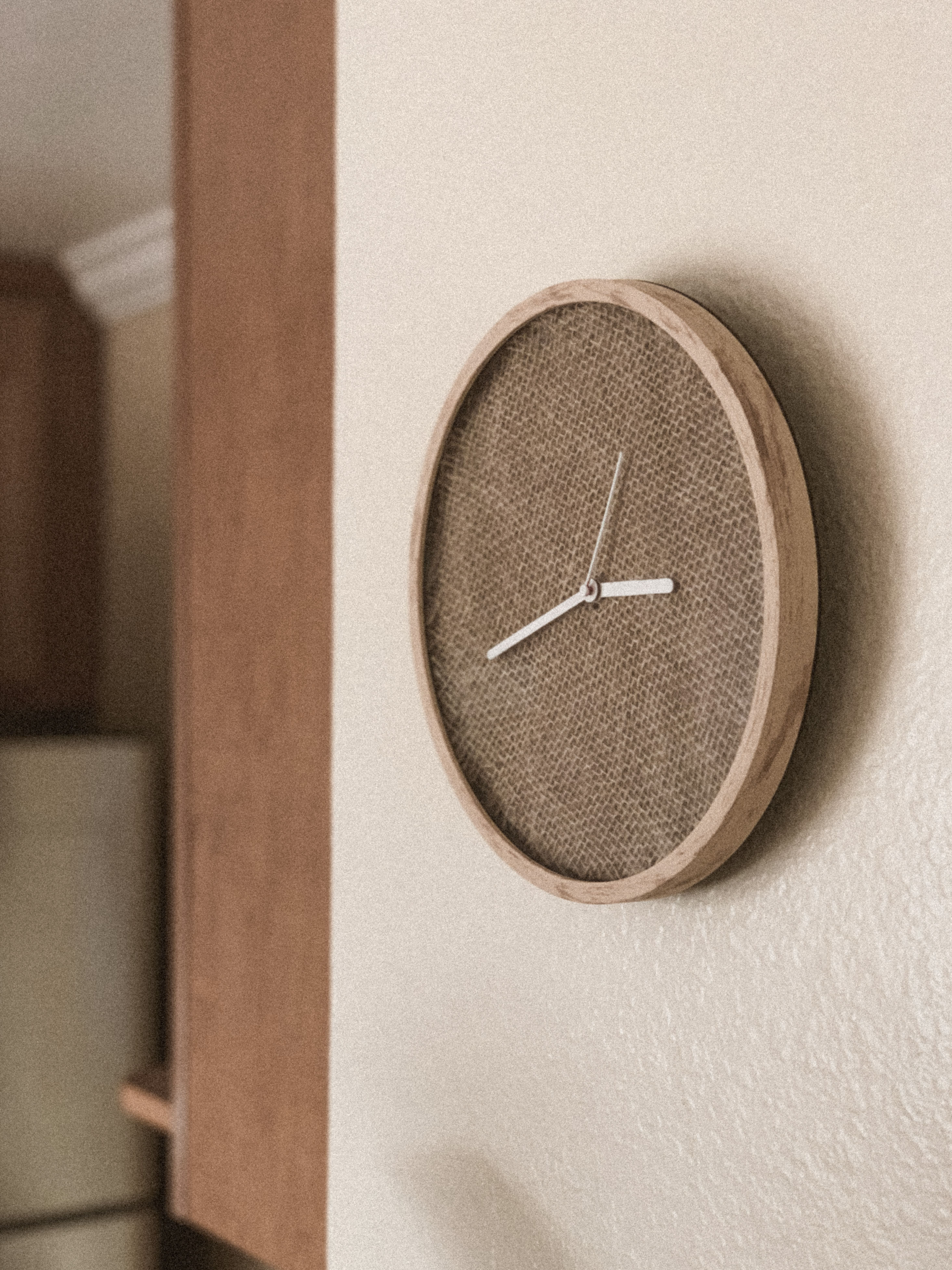 Close up of burlap clock with a lot of texture and detail.