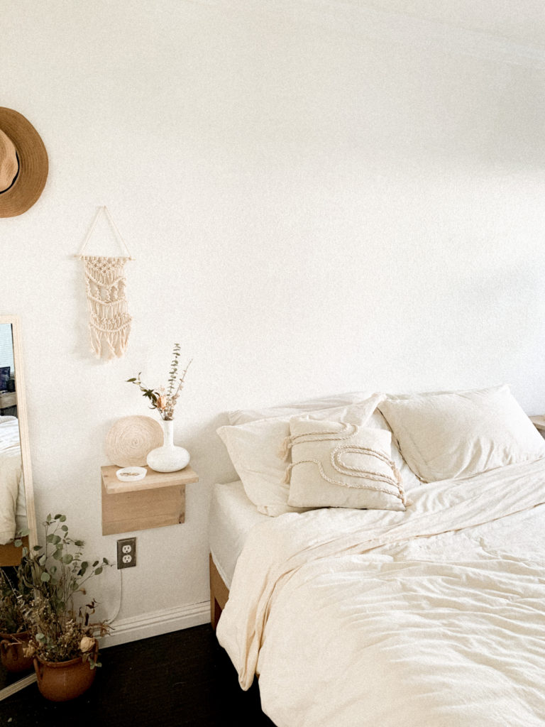Wide view of boho bedroom and Desert Home Co. dish on nightstand. 