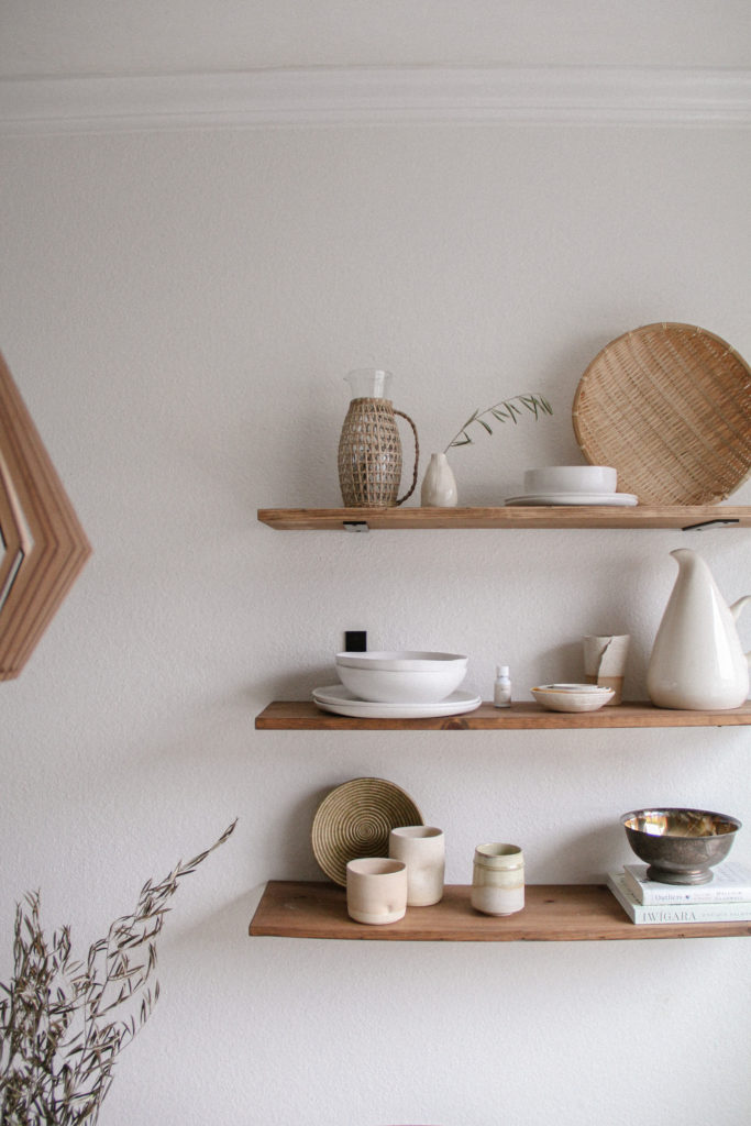 Medium view–– style open shelves with a balance of textures, shapes, and tones. 