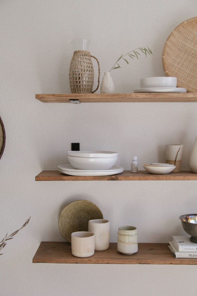 Wood shelves with stacked dinnerware. 